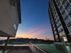 a view of a tennis court between two buildings at Kuantan- Cozy Little Home @Mahkota Valley By VHOME in Kuantan