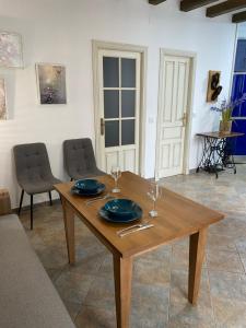 a wooden table with two wine glasses on top of it at “La Carpintería” in Prado del Rey +7 photos