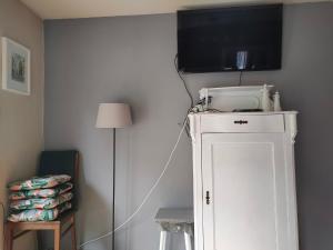 a room with a tv on top of a white cabinet at Marlove Apartment Wrocław in Wrocław