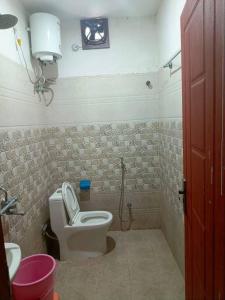 a bathroom with a toilet and a sink at Champaran Home Deluxe in Varanasi