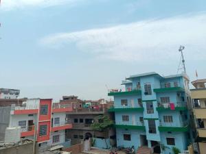 a group of colorful buildings in a city at Champaran Home Deluxe in Varanasi