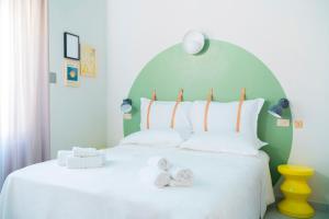 A bed or beds in a room at Hotel Belvedere Rimini