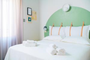 A bed or beds in a room at Hotel Belvedere Rimini