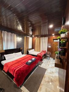 a bedroom with a bed and a couch in it at Gayatri Niwas - Luxury Private room with Ensuit Bathroom - Lake View and Mountain View in Nainital