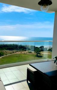 a room with a large window with a view of the ocean at Exclusivo, Moderno y Cómodo Apto temático con hermosa Vista al Mar in Playa Blanca