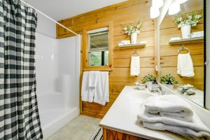 a bathroom with a white sink and a shower at Peaceful Smoky Mountain Cabin with Deck and Fire Pit! in Waynesville +25 photos