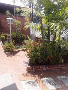 einen Garten mit Blumen, einem Zaun und einem Straßenlicht in der Unterkunft Casa-Quinta c-lindo Amb Familiar in Valencia