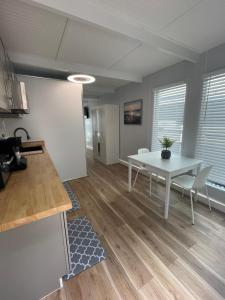 a kitchen and dining room with a white table and chairs at Unique Houseboat Modern and New in Fort Lauderdale