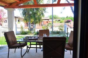 a table and chairs on a patio with a glass table at Ville Dannunzio in Àrbatax