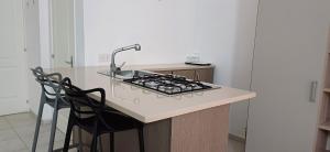 a kitchen with a sink and a stove at NANNI LOFT HOUSE in Castellammare di Stabia