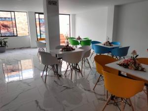 a group of tables and chairs in a room at HOTEL CALIFORNIA in Pitalito
