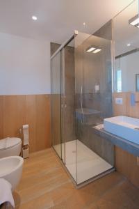 a bathroom with a glass shower and a toilet at La Finestrella in Bari