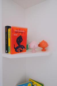 a shelf with two books and a pig toy at La Finestrella in Bari