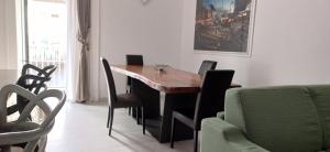 a dining room with a wooden table and chairs at NANNI LOFT HOUSE in Castellammare di Stabia