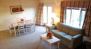 a living room with a couch and a table and chairs at Massanutten Resort in Massanutten