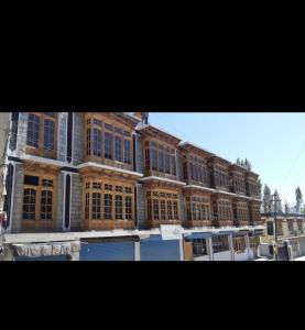 a large building with many windows on a street at Hotel Leh Castle in Leh