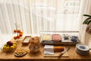 a table topped with different types of food on a table at Hotel San Marco in Savona