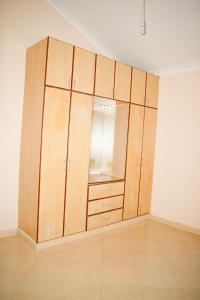 a large wooden cabinet in the corner of a room at Kerith Springs Family Holiday home Bamburi Msa in Bamburi