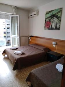 Postel nebo postele na pokoji v ubytování Hotel Lombardia