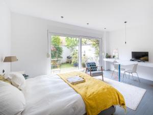 Un dormitorio con una cama grande con una manta amarilla. en Brussels Garden House - 4 bdrs, en Bruselas