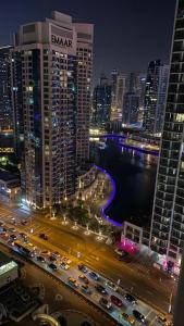 a view of a city at night with traffic at HOMESTAR, Jumeirah Beach Hostel - JBR - Pool, Beach, Metro in Dubai