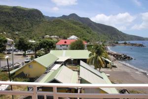 GourbeyreLocation studio vue exceptionnelle proximité mer的从阳台上看到的海滩和房屋