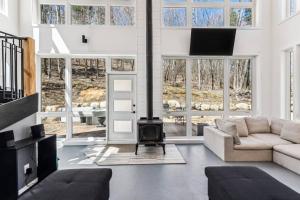 a living room with a couch and a fireplace at Cozy, luminous and charming retreat in Harrington