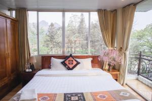 a bedroom with a bed and a large window at Sapa Friendly Inn Hotel in Sa Pa