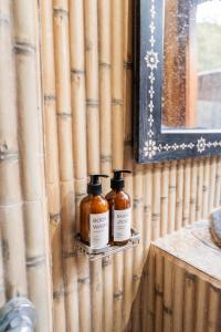 two bottles of honey are sitting on a shelf at Yoki's Bungalow in Kuta Lombok