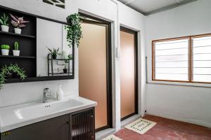 a bathroom with a sink and a mirror at Caryn Vintage Guesthouse in George Town +18 photos