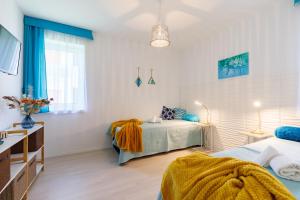 Postel nebo postele na pokoji v ubytování Blue4 Apartment