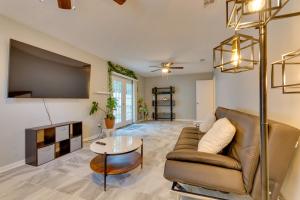 a living room with a couch and a table at Lovely Little Rock Home with Fire Pit and Yard! in Little Rock