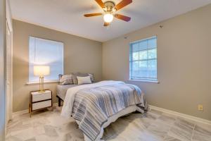 a bedroom with a bed and a ceiling fan at Lovely Little Rock Home with Fire Pit and Yard! in Little Rock
