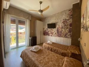 a hotel room with two beds and a window at Hotel Eva La Romantica in Moneglia +112 photos