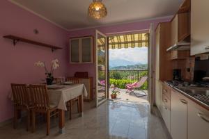 - une cuisine et une salle à manger avec une table et une vue dans l'établissement Casetta di Rosetta, à Arizzano