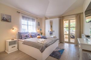 a bedroom with a large bed and a bathroom at Vila Orchidee in Poreč +28 photos