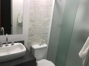 a bathroom with a toilet and a sink and a shower at Hotel Makuxis - Brigadeiro in Sao Paulo +30 photos