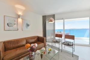 a living room with a couch and a glass table at El Balcon Azul de Taliarte by VillaGranCanaria in Telde