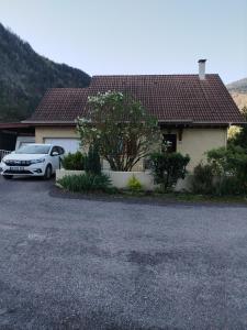 a white car parked in front of a house at Chambre dans maison avec salle de bain collective in Cluses