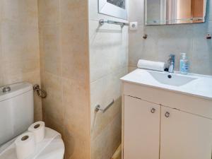 a bathroom with a toilet and a sink at Espalter Onyx by Hello Homes Sitges in Sitges +8 photos