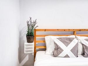 a bedroom with a bed and a potted plant at Espalter Onyx by Hello Homes Sitges in Sitges
