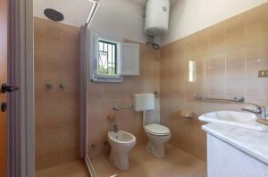 La salle de bains est pourvue de toilettes et d'un lavabo. dans l'établissement Villa Serenità Vintage Charm a Lido Marini, à Lido Marini