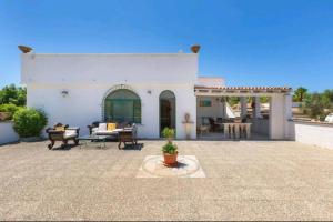 Cette maison blanche dispose d'une terrasse. dans l'établissement Villa Serenità Vintage Charm a Lido Marini, à Lido Marini
