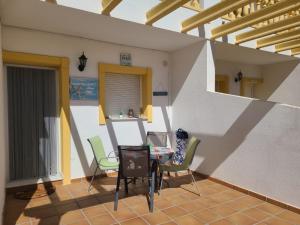 eine Terrasse mit einem Tisch und Stühlen auf einem Haus in der Unterkunft Bungalow PUEBLO MAR en Els Poblets. in Denia