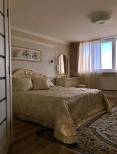 a bedroom with a large bed and a window at Shalanda in Odesa