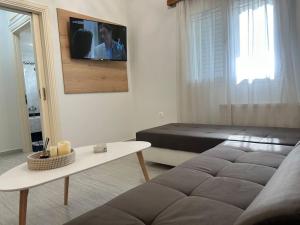 a living room with a couch and a bed at THEODORA SUITE SMART KEY BOX by PROJECT 86 IKE in Agrinio