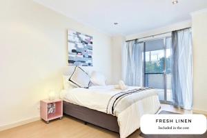 um quarto com uma cama e uma janela em Block Escape - Ocean View Apartment No 1 em Victor Harbor