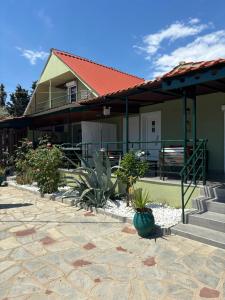 a house with a patio with plants in front of it at Άνεμος Home in Elaiokhórion