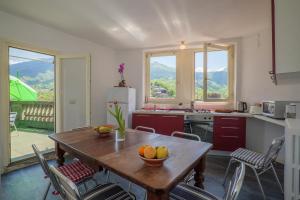 a kitchen with a wooden table with chairs and a tableablish at Casa Terra a Cielo in Castelveccana