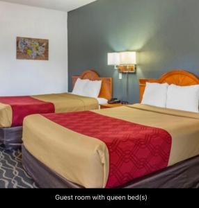 A bed or beds in a room at Econolodge inn & suites